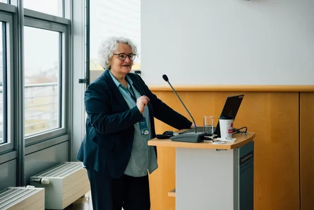 Susann Hampe steht am Rednerpult und spricht zum Publikum